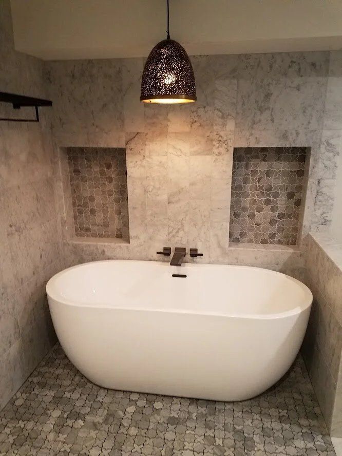 Freestanding tub, marble walls, mosaic floor