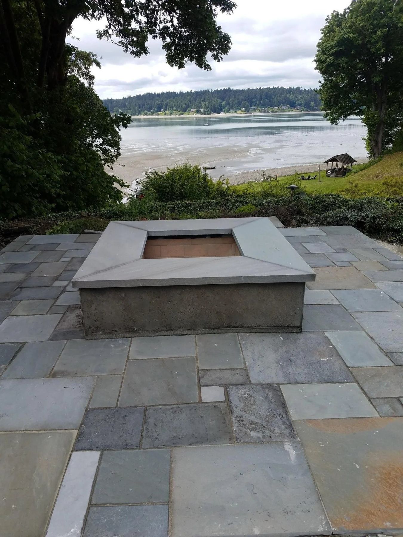Bluestone patio and fire pit above the water