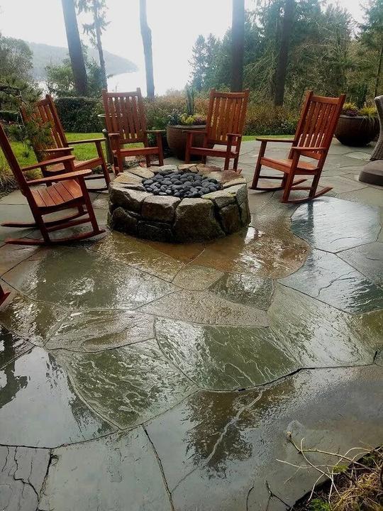 Stone fire pit on a flagstone terrace